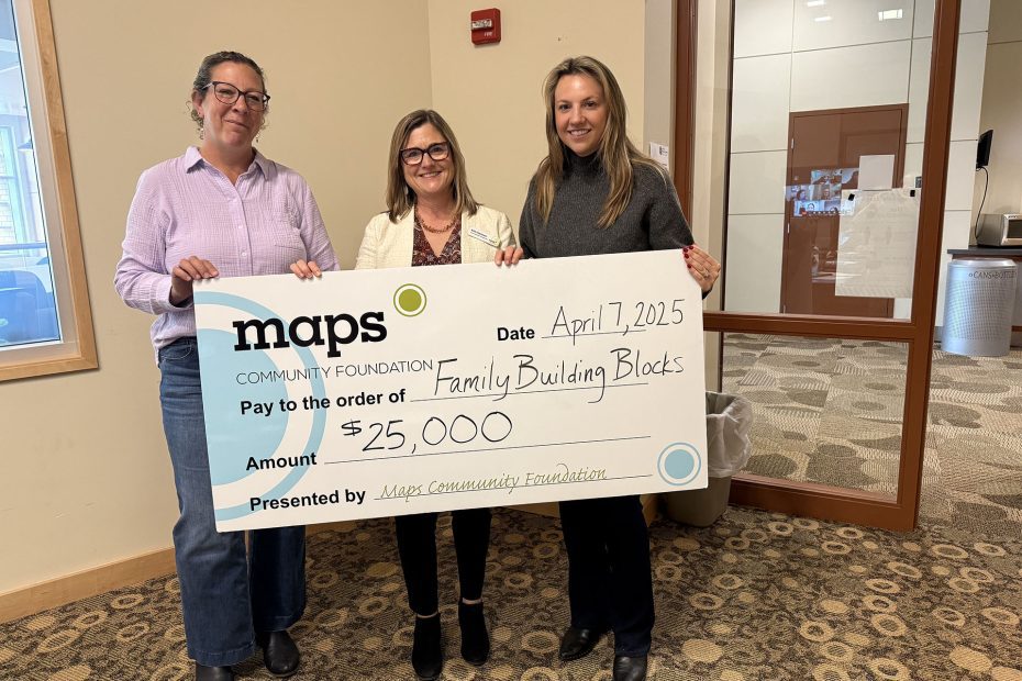 Women holding novelty check for Family Building Blocks