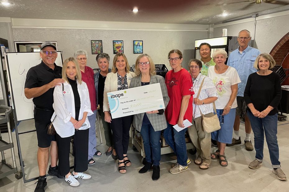Group photo with novelty check for food bank
